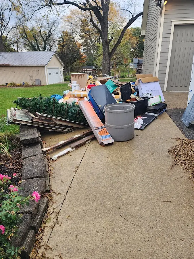 Dumpster being loaded with debris for Roofing Dumpster Rental in Shiloh
